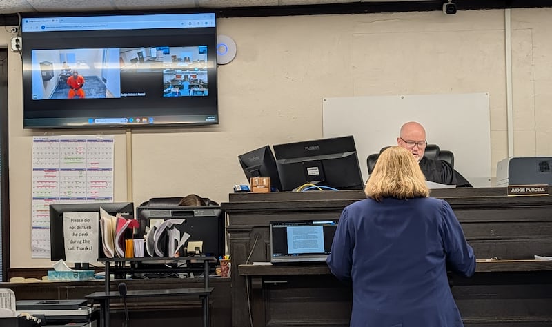 Kankakee County Associate Judge Andrew Purcell granted the Kankakee County State's Attorney Office's petition to detain Julius E. Burkes Feb. 11, 2026. Burkes is wearing orange on the TV screen to the left.