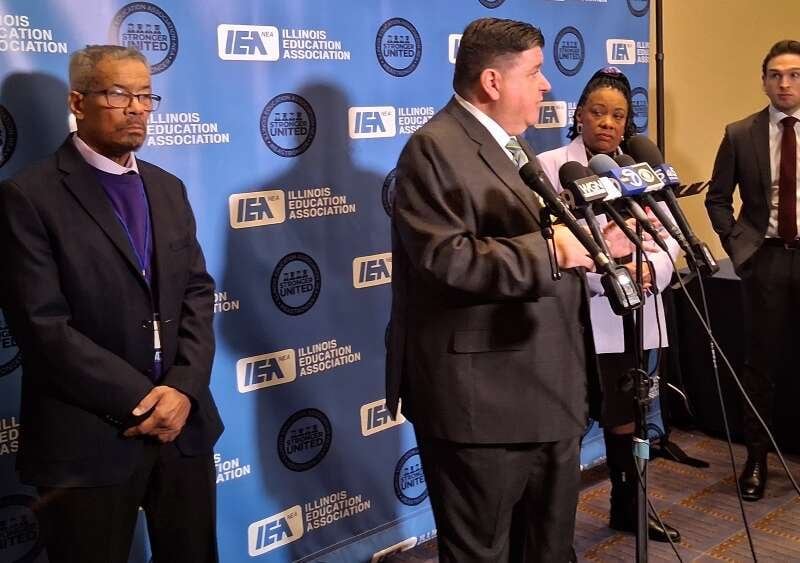 Illinois Gov. JB Pritzker is flanked by Illinois Education Association President Al Llorens, left, and National Education Association President Becky Pringle as they address concerns about the future of the federal Department of Education during IEA's Representative Assembly Thursday.
