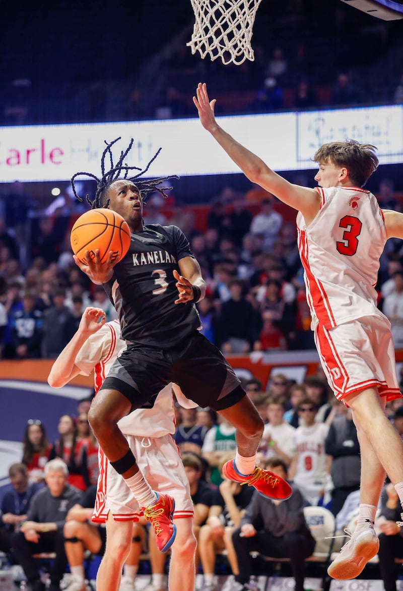 Kaneland's Marshawn Cocroft (3) drives to the hoop past Deerfield's Charlie Yellen (3) during the IHSA Class 3A boys basketball state semifinal Friday, March 13, 2026 at the State Farm Center in Champaign.
