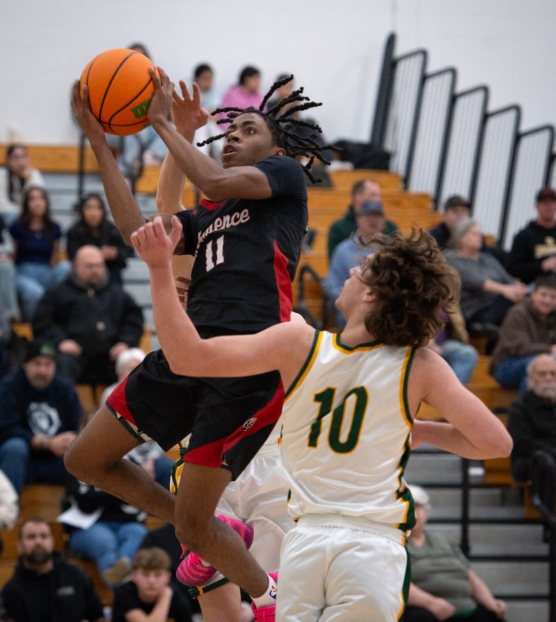 Momence's D'Angelo Hundley elevates for a shot as Grant Park's Tony Valerio, front, guards in a game on Friday, January 16, 2026.