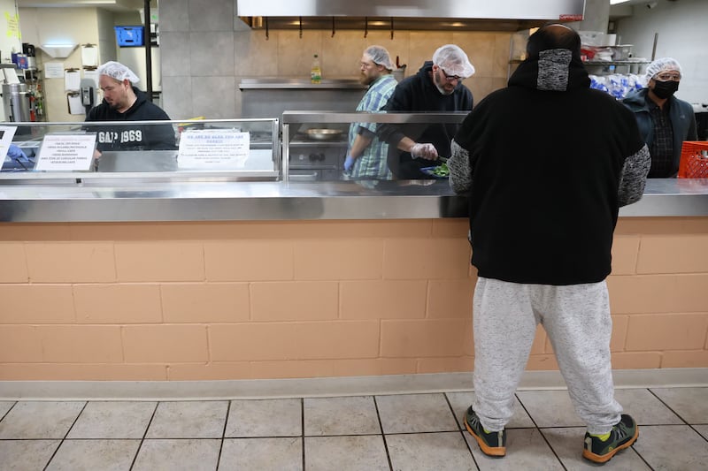 Volunteers serve warm meals at MorningStar Mission shelter in Joliet as temperatures are expected to fall below zero degrees.