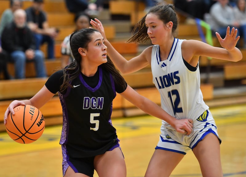 Downers Grove North’s Campbell Thulin (5) looks for an open teammate as Lyons Township’s Sydney Munson (12) defends during a game on January 10, 2026 at Lyons Township High School in LaGrange.