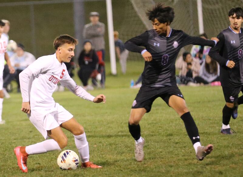 Ottawa's Rory Moore kicks the ball away from Kankakee's Angel Cruz during the Class 2A Regional semifinal game on Monday, Oct. 20, 2025 at Ottawa HIgh School.