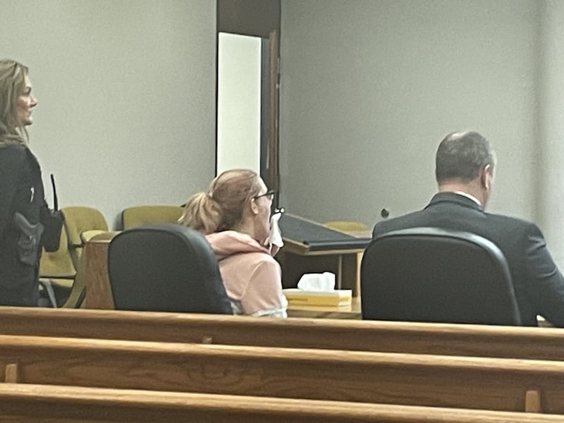 Amanda Rogers of Ottawa (center) wipes away tears Thursday, Feb. 5, 2026, after being sentenced to felony probation (plus a year in county jail) for bilking the federal government of more than $20,000 in COVID-19 relief funds. At right is her lawyer, Public Defender Ryan Hamer.