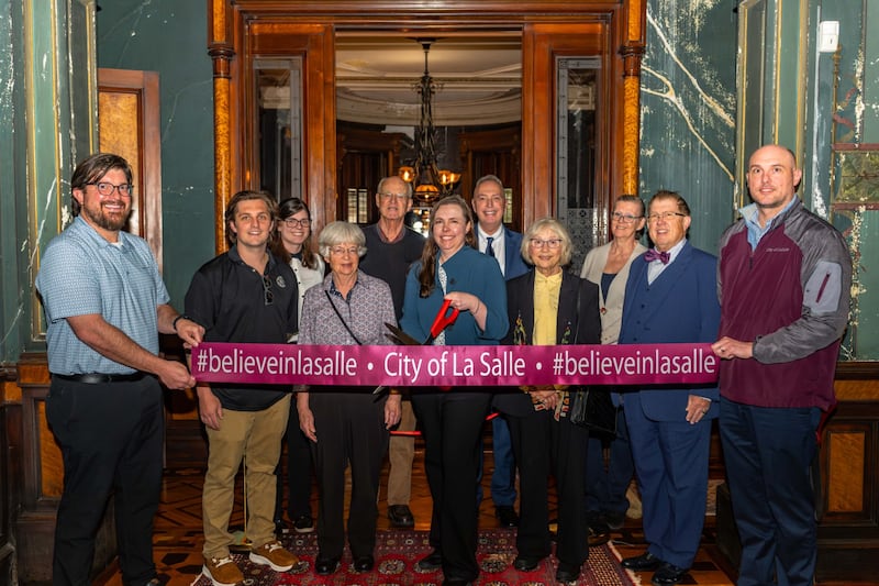 Bill Zens, Josh Kelch, Carol McGee, Laura Walker, Linda Mrowicki, Tim Anderson, Curt Bedei ,Annie Pesola, Jim Nolan, Jay McCracken andApril Murphy celebrate the reopening ceremony at the Hegeler Carus Mansion on Wednesday, April 23.