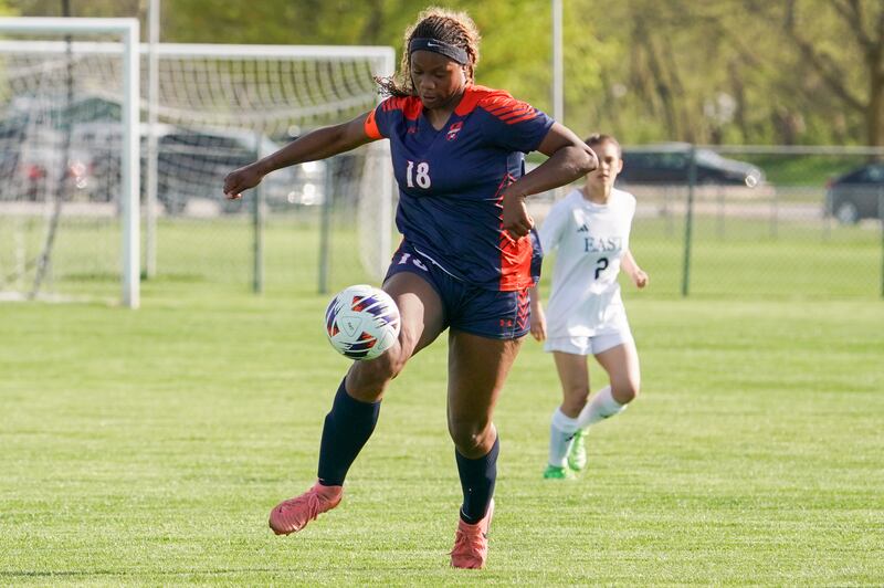 Oswego’s Jordyn Washington (18) plays the ball during a soccer match against Oswego East at Oswego High School on Tuesday, April 29, 2025.