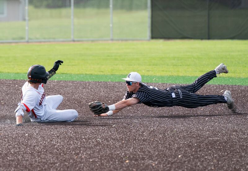 McHenry's Nathan Neidhardt slides into second base safe as Prairie Ridge's Brennan Coyle dives to attempt a tag during their game on Friday, May 16, 2025 at McHenry High School. Ryan Rayburn for Shaw Local