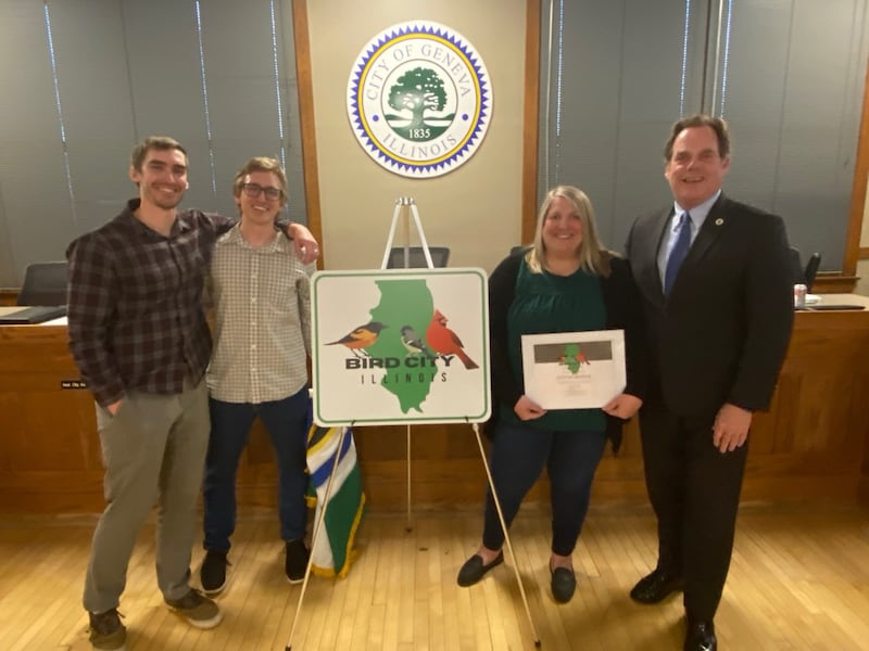 Geneva brothers Kevin (left) and John Potts, were instrumental in getting the Bird City Illinois designation for Geneva, through the Natural Resources Committee. Jennifer Kuroda of the Audubon Council of Illinois and Mayor Kevin Burns unveiled the sign at the April 20, 2026 City Council meeting.