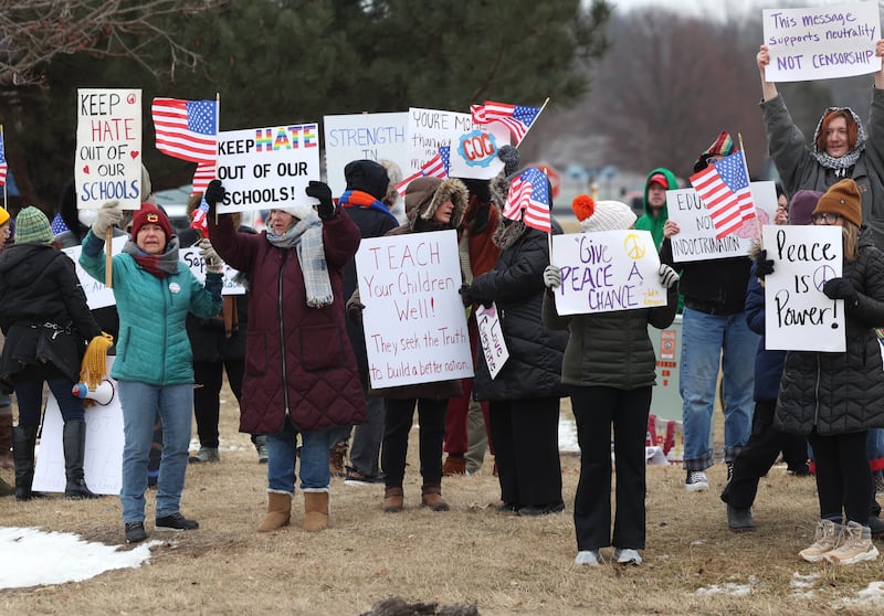 Protesters hold signs Thursday, Feb. 5, 2026, in front of Genoa-Kingston High School. The group is protesting the “History Rocks” assembly which is part of a nationwide campaign by the U.S Department of Education tied to the nation’s 250th anniversary and organized by the high school’s Turning Point USA, Club America chapter, a nonprofit founded in 2012 by the late Charlie Kirk.