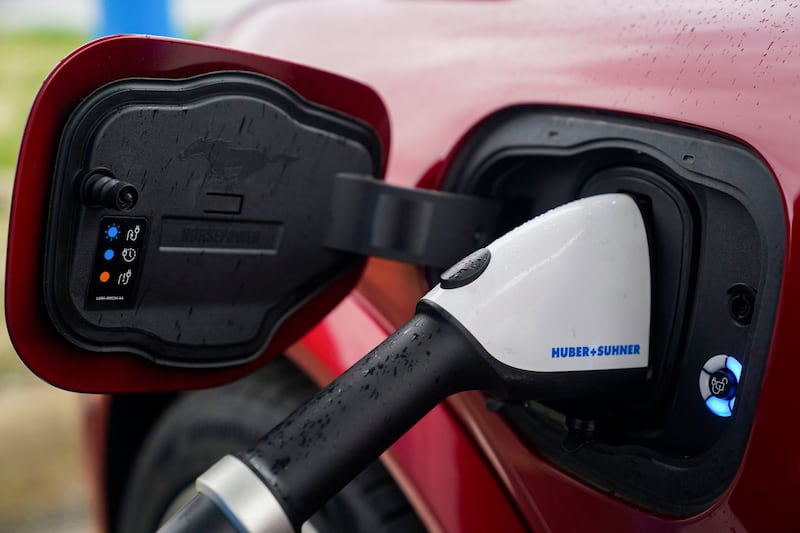 A 2023 Ford Mustang Mach-E charges, March 8, 2024, at an electric vehicle charging station in London, Ohio.