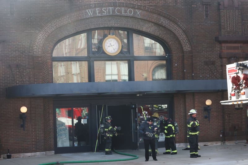 Firefighters gather outside of Fire On Fifth in the Westclox building on Tuesday, Jan. 20, 2026 in Peru. A working fire started in the storage room inside of Fire on Fifth. The fire started at 10a.m. Fire departments from Utica, Oglesby Peru and La Salle all assisted on the scene. La Salle and Peru EMS were also dispatched. The entire Westclox building was evacuated. Two employees were transported by ambulance for smoke inhalation. A smoke detector inside Star Union Spirits triggered an alarm, prompting a fast response from firefighters.