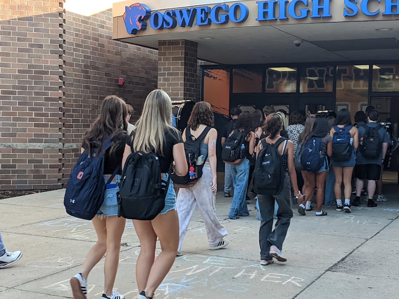 Students walk into Oswego High School for the first day of the fall semester on Thursday, Aug. 14, 2025.