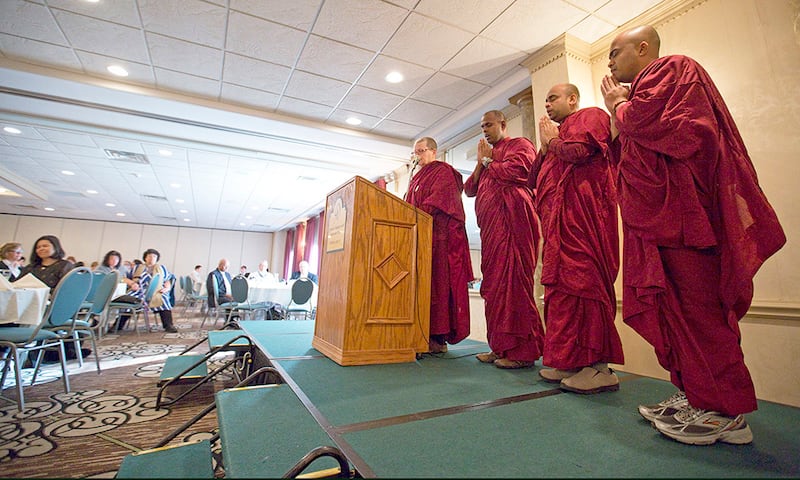 Monks from the Blue Lotus Buddhist Temple in Woodstock (L-R) BhanteSumana, Bhante Dhammadassi, Bhante Amitha and Bhikkhuni Vimala chant during a meditation session in the closing of FaithBridge's fifth annual Martin Luther King Jr. Interfaith Prayer Breakfast on Monday, Jan. 19, 2015, in Crystal Lake.