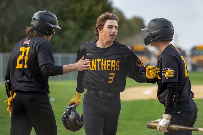 Johnathan Stunkel (3) of Putnam County celebrates home run with teammates Tayton Kays (21) and Kade Zimmerlein (7) on Thursday, April 17, 2025 at Woodland High School in Streator.