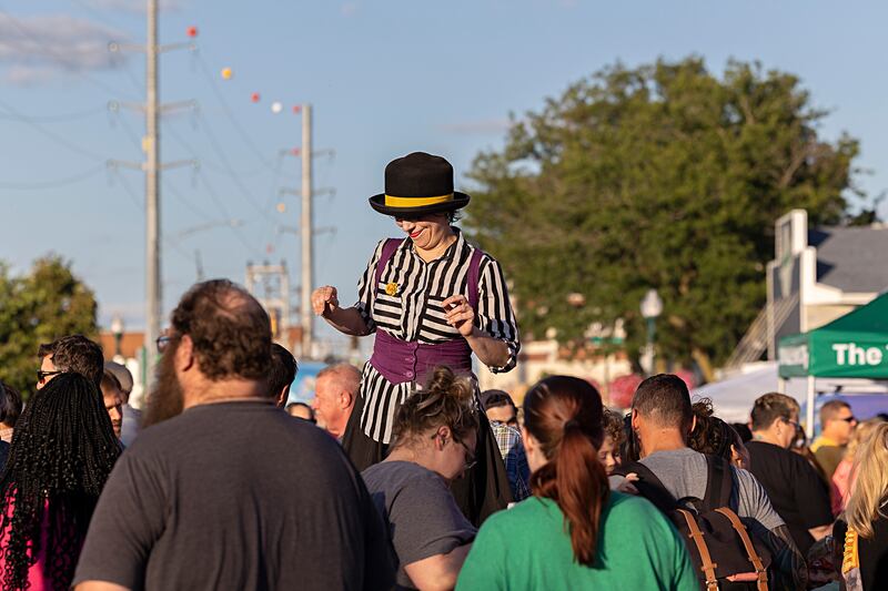 Wearing stilts, street performer Raquel Torre rises above the crowd Saturday, Aug. 10, 2024, during Dixon’s Venetian Night. Street performers, masks, music, food, magic and fireworks were all found at the riverside festival.