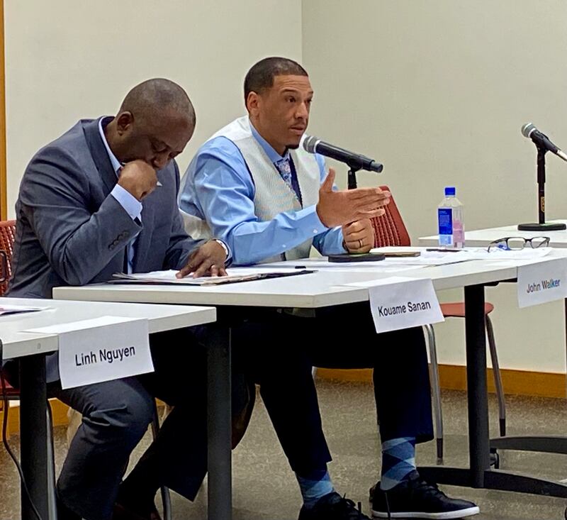 DeKalb candidate for mayor John Walker (right), who currently represents the 7th Ward on the DeKalb City Council, answers an audience question while opponent Koume Sanan (left) listens at a candidate forum hosted by WNIJ radio and the DeKalb Election Group on Sunday, March 9, 2025, at the DeKalb Public Library, 309 Oak St.