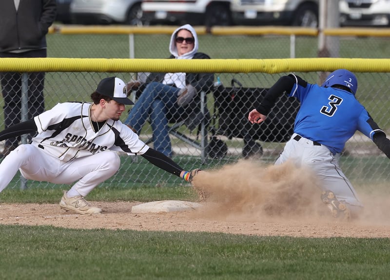 St. Charles North's Cameron Chickerneo slides in safely with a stolen base as Sycamore's Tenton Meisch applies the late tag during their game Thursday, April 10, 2025, at the Sycamore Park District Sports Complex.