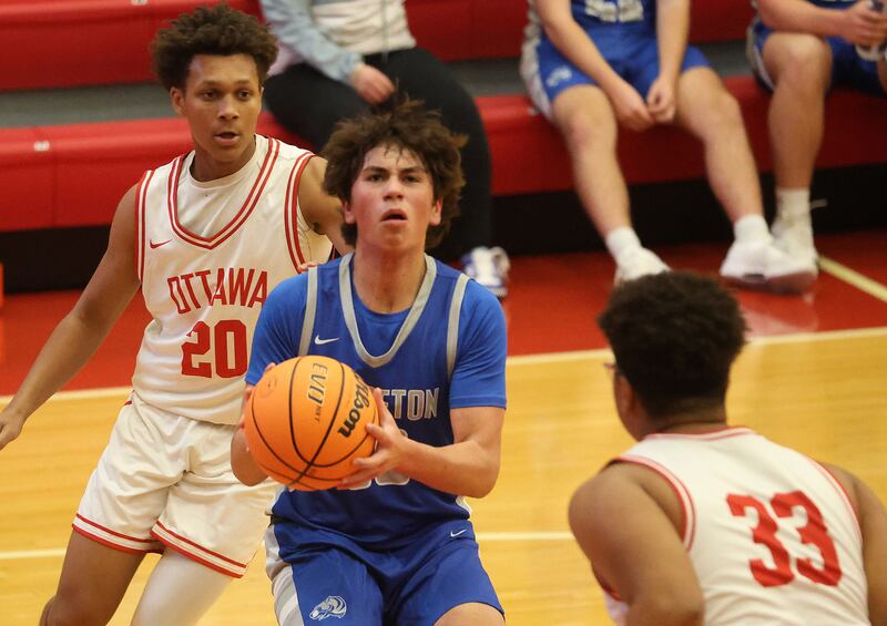 Princeton's Cayden Benavidez eyes the hoop as he splits Ottawa defenders Jerrimahia Jones and teammate Carson Keylard during the Dean Riley Shootin' The Rock Thanksgiving Tournament on Monday Nov. 24, 2025 in Kingman Gymnasium at Ottawa High School.