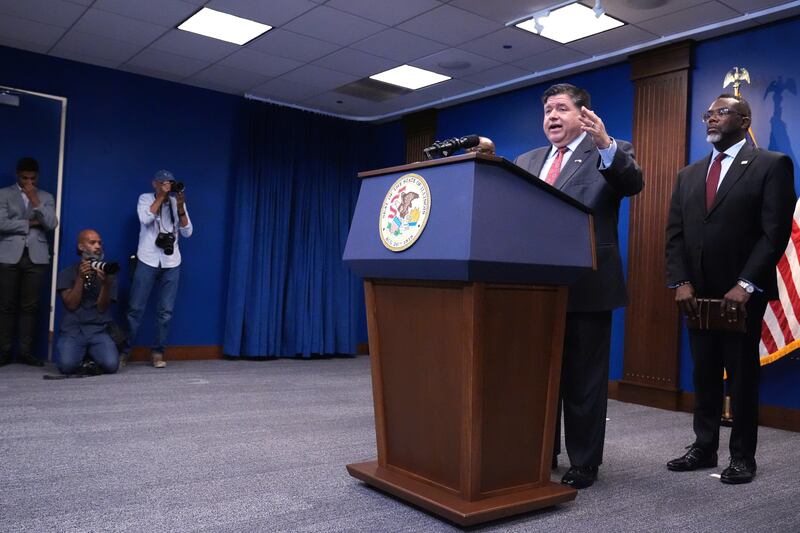 Governor JB Pritzker, second from right, speaks as Chicago Mayor Brandon Johnson, right, listens to him at a news conference in Chicago, Monday, Oct. 6, 2025. (AP Photo/Nam Y. Huh)