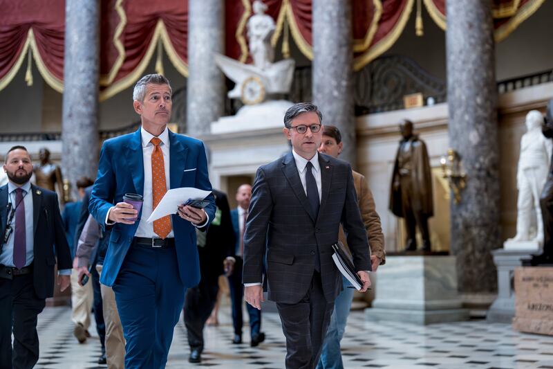 Transportation Secretary Sean Duffy, left, and Speaker of the House Mike Johnson, R-La., walk through Statuary Hall at the Capitol to a news conference on day 23 of the government shutdown, in Washington, Thursday, Oct. 23, 2025. (AP Photo/J. Scott Applewhite)