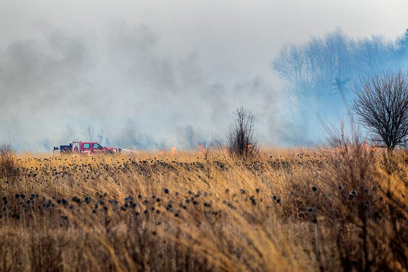 Harmon firefighters respond to a wildfire Friday, March 14, 2025, at Green River State Wildlife Area south of the town. Strong winds made fighting the fire much more difficult and dangerous. Departments from Ohio, Tampico and Wyanet were also seen fighting the blaze. Though the area is sparsely populated, some local residents were evacuated from the area.