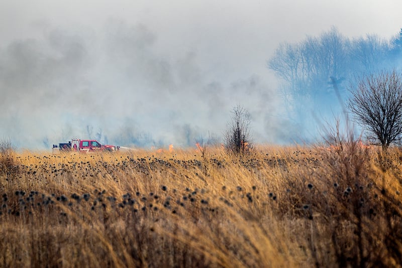 Harmon firefighters respond to a wildfire Friday, March 14, 2025, at Green River State Wildlife Area south of the town. Strong winds made fighting the fire much more difficult and dangerous. Departments from Ohio, Tampico and Wyanet were also seen fighting the blaze. Though the area is sparsely populated, some local residents were evacuated from the area.