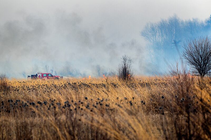 Harmon firefighters respond to a wildfire Friday, March 14, 2025, at Green River State Wildlife Area south of the town. Strong winds made fighting the fire much more difficult and dangerous. Departments from Ohio, Tampico and Wyanet were also seen fighting the blaze. Though the area is sparsely populated, some local residents were evacuated from the area.