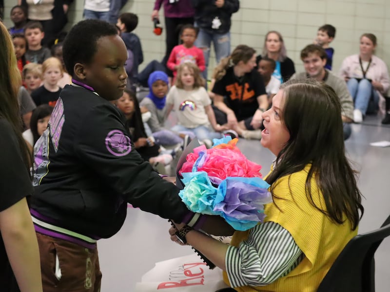 Jefferson Elementary School Principal Melanie Bickley accepts gifts from Jefferson students on National Principal's Day. She also received another surprise during the assembly on May 1, 2025: She was named Administrator of the Year by the Illinois Association for Health, Physical Education, Recreation and Dance.