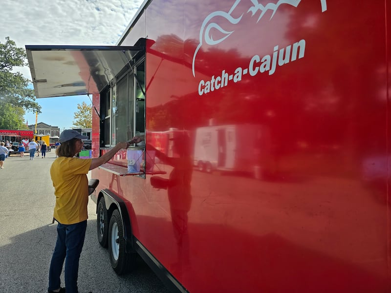 Catch-a-Cajun serves a customer Saturday, Sept. 14, 2024, during the Fall Food Truck Festival in Streator's City Park.