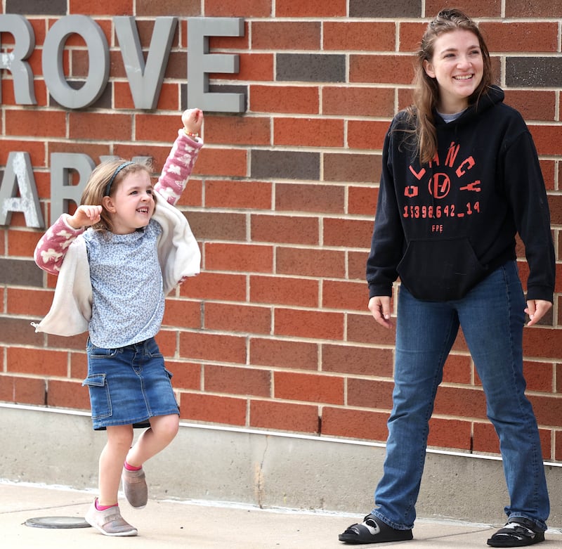 Kindergartener Charley Hollis dances to the music with her mom Sarah Curry Thursday, Aug. 21, 2025, as they arrive for the first day of school at North Grove Elementary School in Sycamore.
