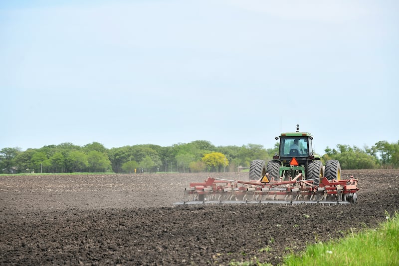 A farmer tills a field in rural Kankakee near Grinnell Road as planting began in 2024.