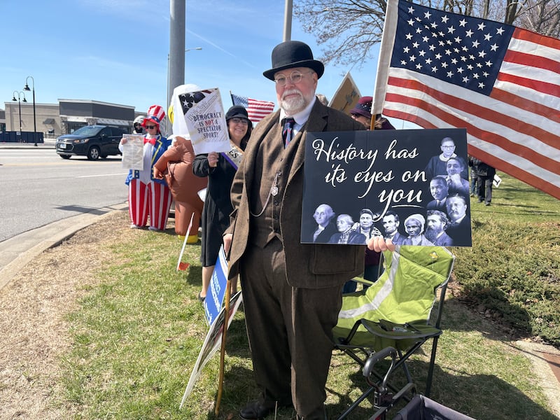 Diane Ayers, left and Rusty Ayers, wear outfits from the era of women's suffrage at a No Kings rally in Crystal Lake, Saturday, March 28, 2026.