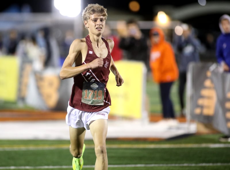 Plainfield North’s Thomas Czerwinski runs to the finish in the varsity boys race during the Naperville North Twilight Cross Country Invitational on Wednesday, Oct. 9, 2024 in Naperville.