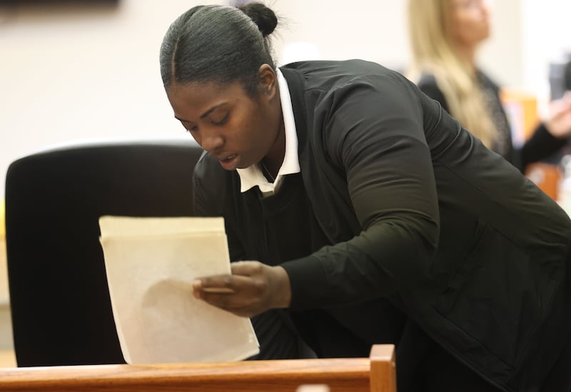 Ebony Green of University Park, gathers her paperwork before her sentencing in the courtroom on Thursday, Jan. 29, 2026 at the La Salle County Governmental Complex in Ottawa. Green claimed to run a day care service in Ottawa with earnings of $100,000, but Ebony Green was actually a hairstylist earning a fraction of that. Yet she received a COVID-19 relief loan for almost $20,000.