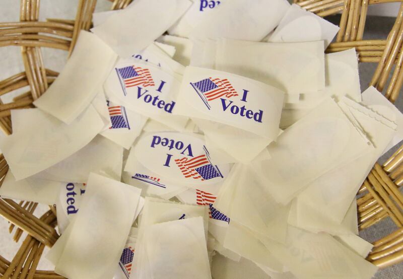 A basket full of "I Voted" stickers rests near the ballot machine at Zion United Church of Christ on Tuesday, Nov. 5, 2024 in Peru.