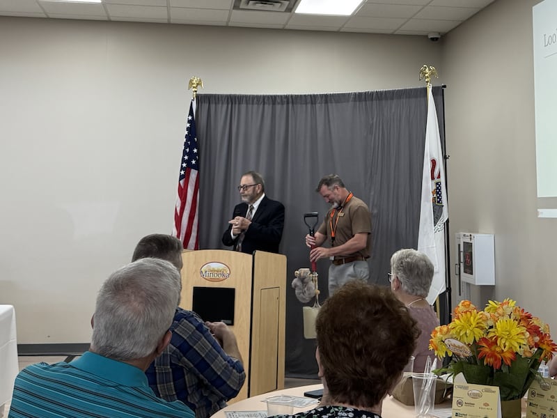 Minooka Village President Ric Offerman (left) presents Ryan Anderson with a commemorative shovel as he leaves the village's Public Works division. Photo taken on Tuesday, April 14, 2026.