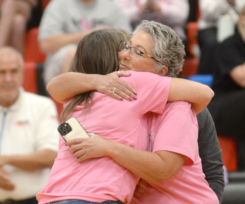 Fulton High School volleyball coach Stacy Germann embraces Rene Sanquist during the Volley for the Cure event on Tuesday, Oct. 7, 2025 at Fulton High School.  Sanquist is battling breast cancer and was the recipient of the proceeds from the event.