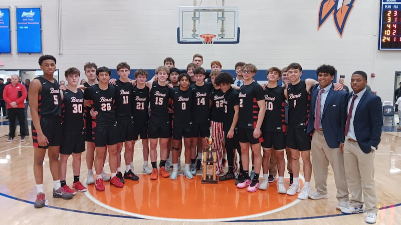 The Benet boys basketball team poses with the championship plaque after winning the 94th Pontiac Holiday Tournament on Wednesday, Dec. 31.