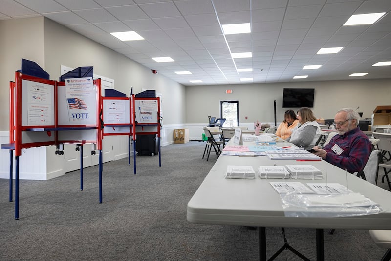 Election judges pass the time between voters Tuesday, March 17, 2026, at Harvest Time Church in Rock Falls. The judges saw slow voter turnout for this March primary.