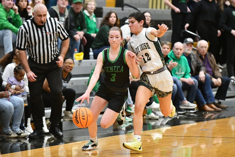 Seneca's Evelyn O'Connor drives up the court against Bishop McNamara's Analeah Ramirez during the Lady Irish's 51-30 loss to Bishop McNamara in the IHSA Class 2A Herscher Sectional semifinal on Tuesday, Feb. 25.