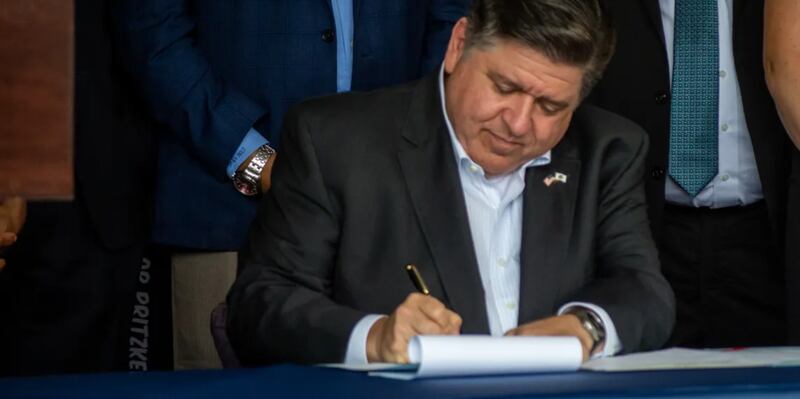Gov. JB Pritzker signs a bill in Springfield on Thursday, August 14, 2025.