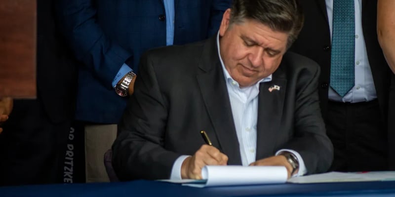 Gov. JB Pritzker signs a bill in Springfield on Thursday, August 14, 2025.