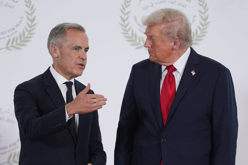 President Donald Trump greets Canada's Prime Minister Mark Carney during a summit to support ending the more than two-year Israel-Hamas war in Gaza after a breakthrough ceasefire deal, Monday, Oct. 13, 2025, in Sharm El Sheikh, Egypt. (AP Photo/Evan Vucci, Pool)