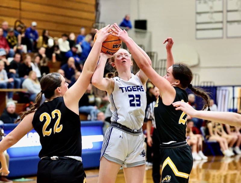 Princeton junior Danika Burden muscles up for a shot between Riverdale's Katie Cox and Jillian Murray Tuesday night at Prouty Gym. The visiting Rams won 54-33.