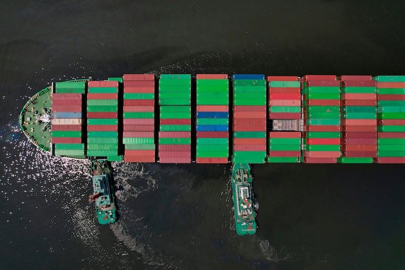FILE - Tugboats assist a container ship as it prepares to dock at the Manila International Container Terminal at the Philippine capital April 8, 2025. (AP Photo/Aaron Favila, File)