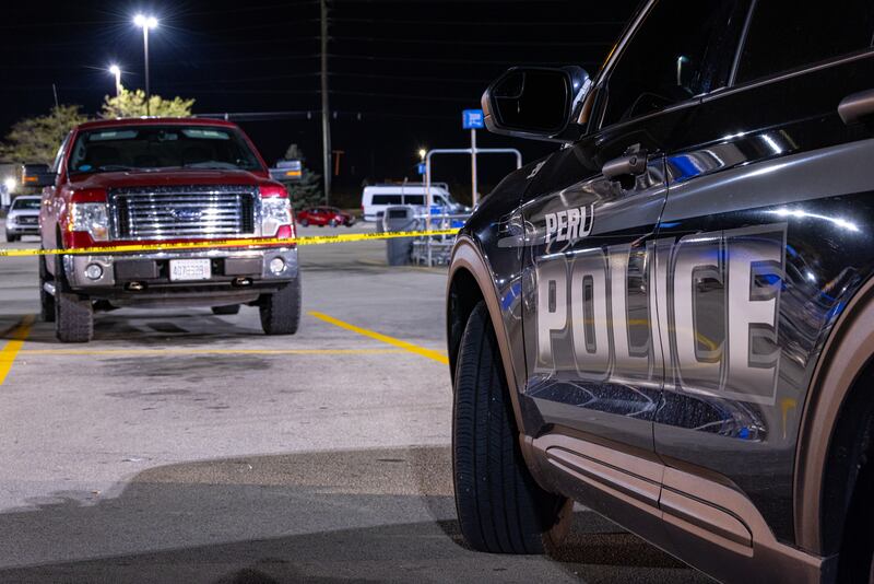 A Police Interceptor sits guarding a suspicious vehicle in the parking lot of the Peru Walmart on Thursday, September 25, 2025 in Peru.