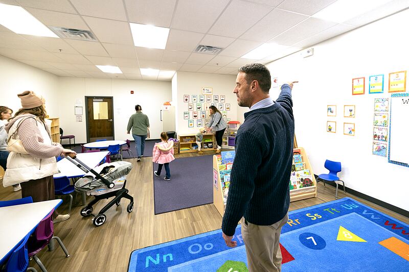 Dixon YMCA director Andrew McFarlane gestures while directing visitors to the new child care center Thursday, Jan. 9, 2025.