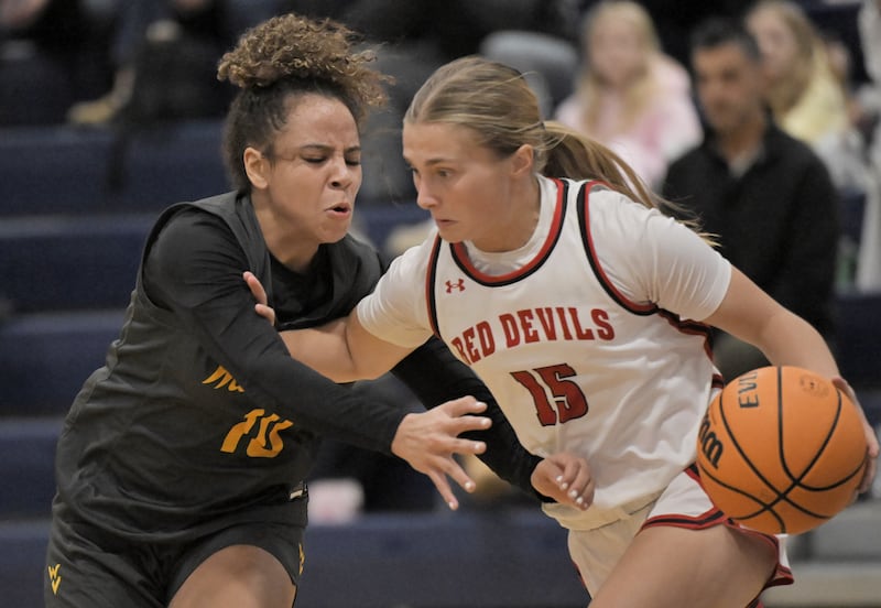 Waubonsie Valley’s Danyella Mporokoso guards Hinsdale Central’s Katherine Coffey in a semifinal game of the Wheaton North girls holiday tournament in Wheaton on Friday, Dec. 26, 2025.