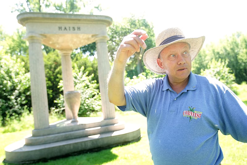 Historian Steve Bigolin explains the history behind Jacob Haish's nearly 20-foot-tall headstone in Fairview Park Cemetery in DeKalb on Monday, July 7, 2014. At the time of the headstone design, the main entrance to the cemetery was designed to be a winding road off of 1st St. and was later changed to have the current entrance on 4th St. in DeKalb.