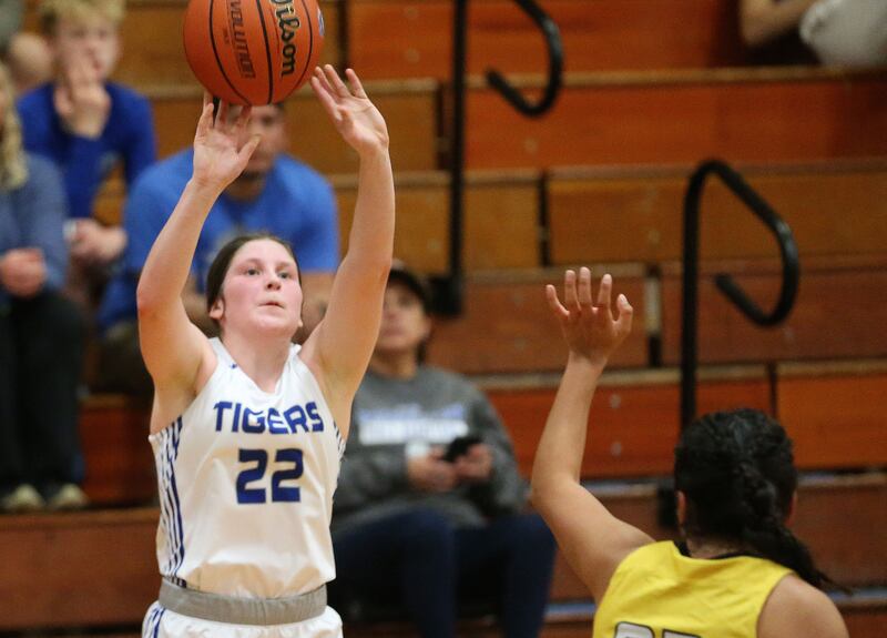 Princeton's Camryn Driscoll lets go of a shot over Putnam County's Valeria Villagomez during the Princeton Holiday Girls Basketball Tournament on Tuesday, Nov. 19, 2024 at Princeton High School.